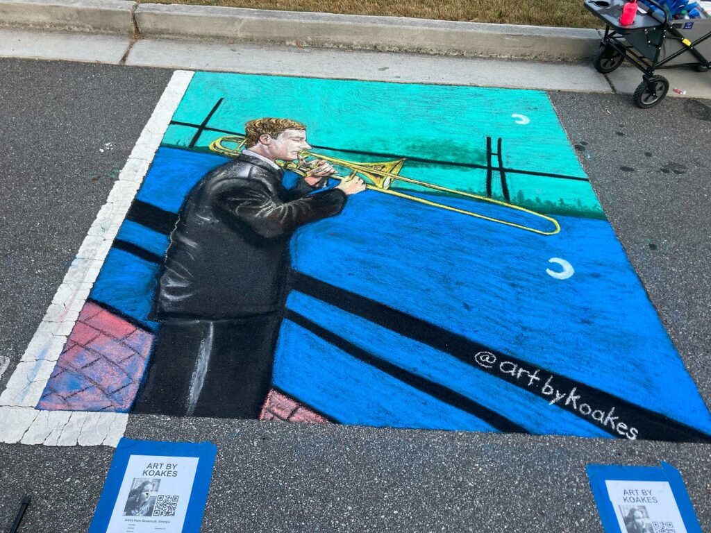 chalk art drawing of a musician playing trombone in front of a river